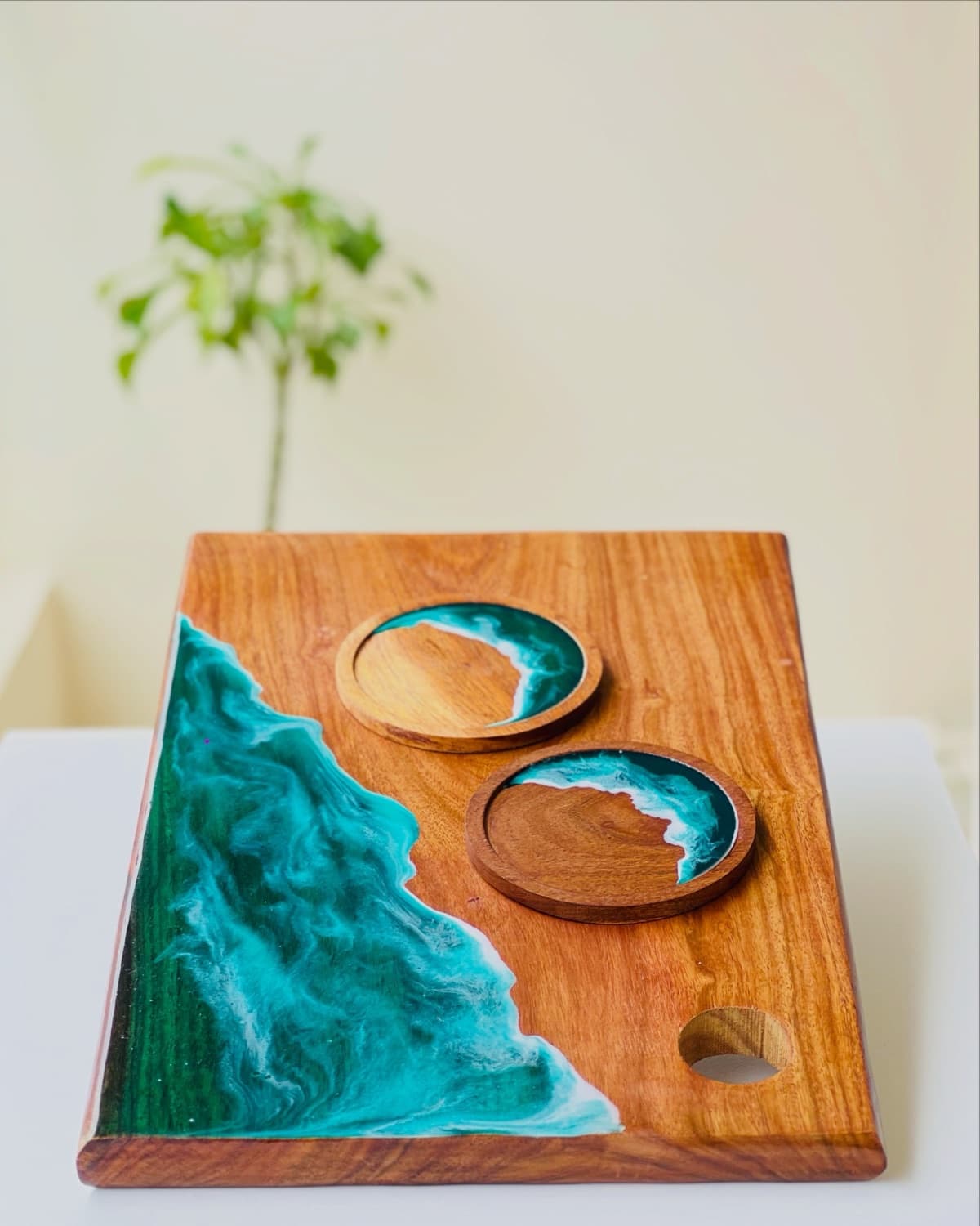 A handmade Pour & Pine ocean-resin board styled with matching coasters